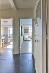 a hallway with a door leading to a living room at Res. Golf Zoute in Knokke-Heist