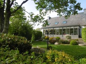 an exterior view of a house with a garden at La Maison de Marie in Kérien