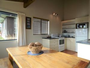 a kitchen with a wooden table with a basket on it at Nomads Rest in Lake Tekapo