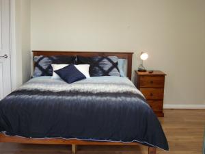 
a bed in a bedroom with a wooden headboard at Ruby Rose in Simpson
