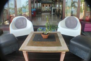 two chairs and a table with a potted plant at Villa Alcheringa Parangtritis in Parangtritis