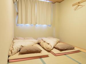 
a bedroom with a bed and a window at Kyoto Hana Hostel in Kyoto
