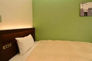 Postel nebo postele na pokoji v ubytování Hotel Sunroute Sano