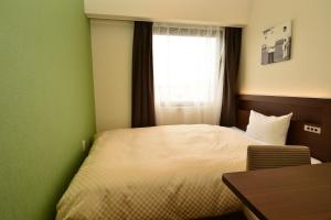 Postel nebo postele na pokoji v ubytování Hotel Sunroute Sano