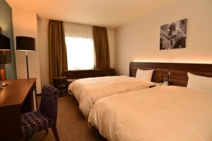 เตียงในห้องที่ Hotel Sunroute Sano