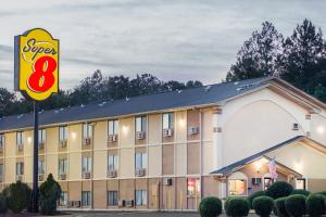 a hotel with a sign in front of it at Super 8 by Wyndham Warner Robins in Warner Robins
