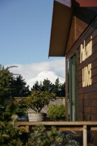 a view of a snow covered mountain through a window at Pukenui Lodge in National Park