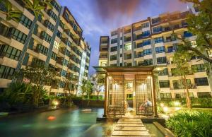 a building with a pool of water in front of a building at Centrio by Suttirak in Phuket