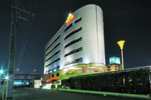 a hotel building with a sign on top of it at HOTEL SOL in Fukuoka