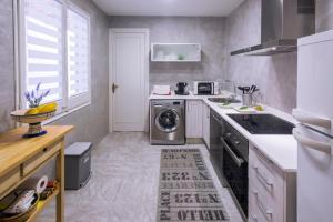 a kitchen with a washer and dryer in it at Can Mero in Malgrat de Mar