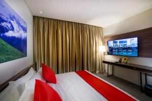 Riccarton Capsule Hotel tesisinde bir odada yatak veya yataklar