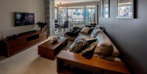 a living room with a couch and a table at Darling Harbour Getaway in Sydney