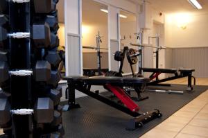 a gym with two treadmills and weights at Hotell Kung Gösta in Mora