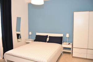ein Schlafzimmer mit einem Bett und zwei Nachttischen in der Unterkunft sophie in Salerno