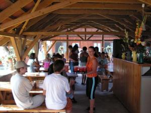 a group of people sitting at tables in a restaurant at Faház Motel in Abádszalók