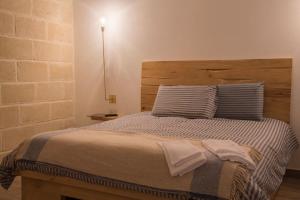 a bedroom with a bed with two towels on it at Masseria Straziuso - La Vaccariccia in San Chirico Nuovo