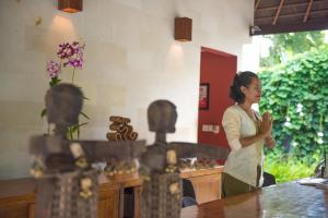 a woman standing in a kitchen with her hands at The Chandi Boutique Resort & Spa in Senggigi +37 photos