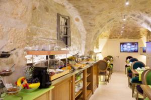 a restaurant with a buffet in a stone building at Le Relais Saint Honoré in Paris