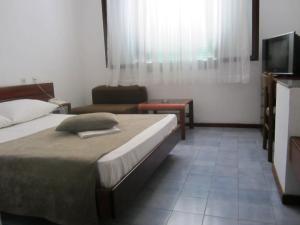 Postel nebo postele na pokoji v ubytování Hotel Zenit Neum