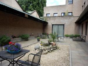 a patio with a table and chairs and a fire pit at Condo Gardens Brussels in Brussels