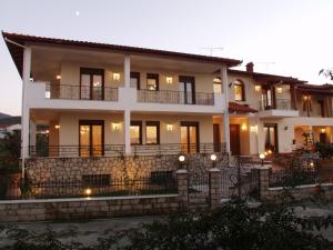 a large white house with lights on it at Hotel Archontiko Dimitra in Vergina