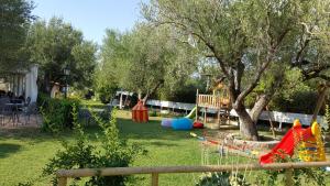 a yard with a tree and a playground at Residence e B&B Villamirella in Palinuro