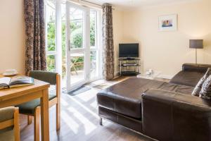 a living room with a couch and a table at Gwithian Holidays in Hayle