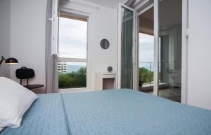 a bedroom with a bed and a large window at Apartment Morska vila in Split
