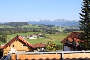 a view of a village with mountains in the background at Haus Lenzhalde in Oberreute
