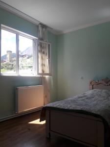 a bedroom with a bed and a window at Tako's house in Mestia +193 photos