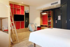 a bedroom with a bed and a room with a ladder at Ibis Saigon Airport in Ho Chi Minh City