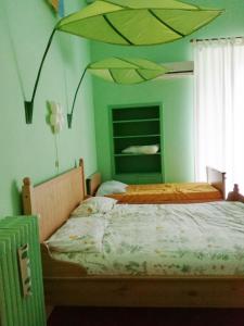 two beds in a bedroom with a painting on the wall at HOUSE of COLORS in Bari