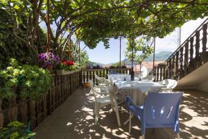 a row of tables and chairs on a patio at St. Roko Guest House in Tivat