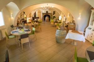 a restaurant with tables and chairs in a room at La Cauquière By L'Epicurienne in Le Beausset