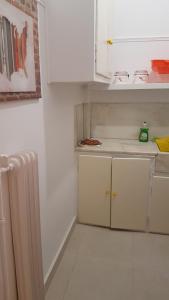 アテネにあるErrathens Yellow Studioの白い小さなキッチン(シンク、冷蔵庫付)