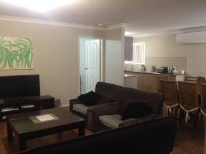 a living room with a couch and a table at Surf Mist in Nowra
