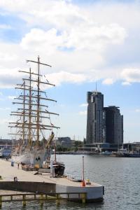 a tall ship docked at a dock in the water at Apartamenty Sea Towers in Gdynia