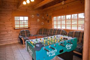 a room with a foosball table in a cabin at Adomo Sodyba in Dubingiai