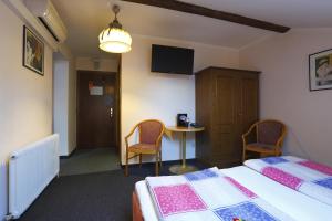 Giường trong phòng chung tại Alpen.Adria.Stadthotel