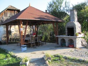 a gazebo with a fireplace in a yard at Casa Toma in Sovata