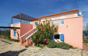 a house with a staircase in front of it at Holiday House Ivana in Dobropoljana