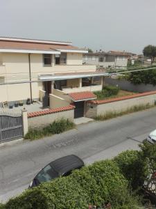 a car parked in front of a house on a street at B&B melody in Fiumicino