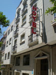 a building with a sign on the side of it at Hotel Europa in Cambados