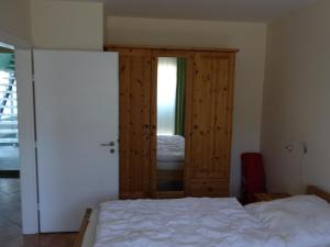 a bedroom with a bed and a wooden door at Strandleben 4 in Grömitz