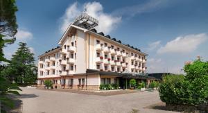 a large white building with a clock on top of it at Hotel Al Pino Verde in Camposampiero