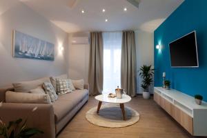 a living room with a couch and a table at Sunny Garden Lux in Split