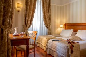 Postel nebo postele na pokoji v ubytování Albergo Ottocento