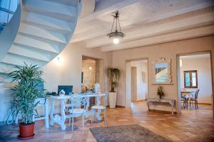 a dining room with a table and chairs and a staircase at Antica Quercia Villa & Spa in Chianciano Terme