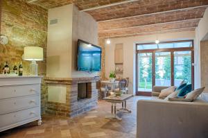 a living room with a couch and a fireplace at Antica Quercia Villa & Spa in Chianciano Terme