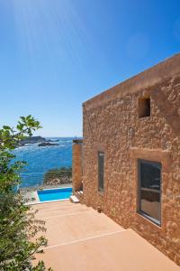 a stone house with a view of the ocean at Elafonisi Villas in Livadia